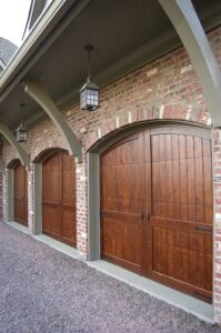 custom wood garage doors on brick home